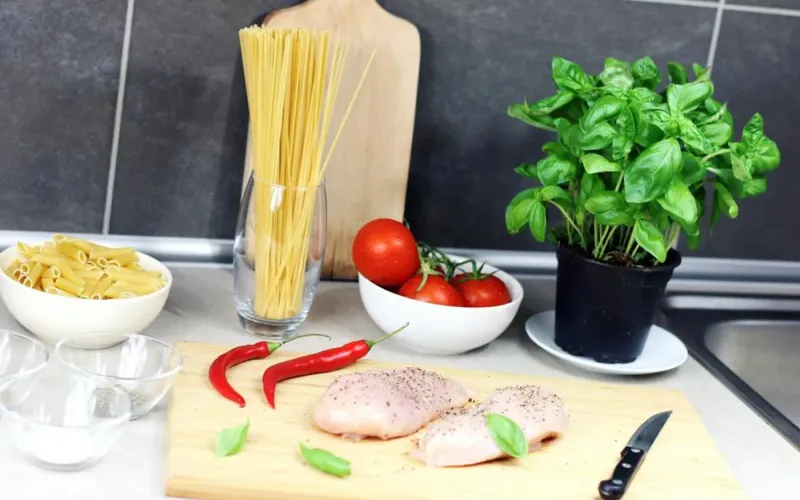 Fresh ingredients laid out on a kitchen worktop ready for cooking