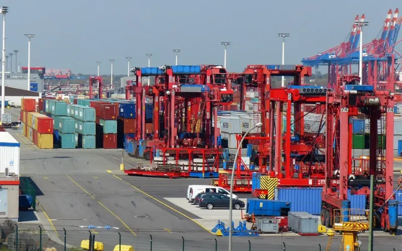Container terminal with cranes loading shipping containers for export