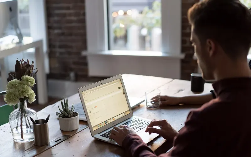 Man at a laptop in an office — Helm Software